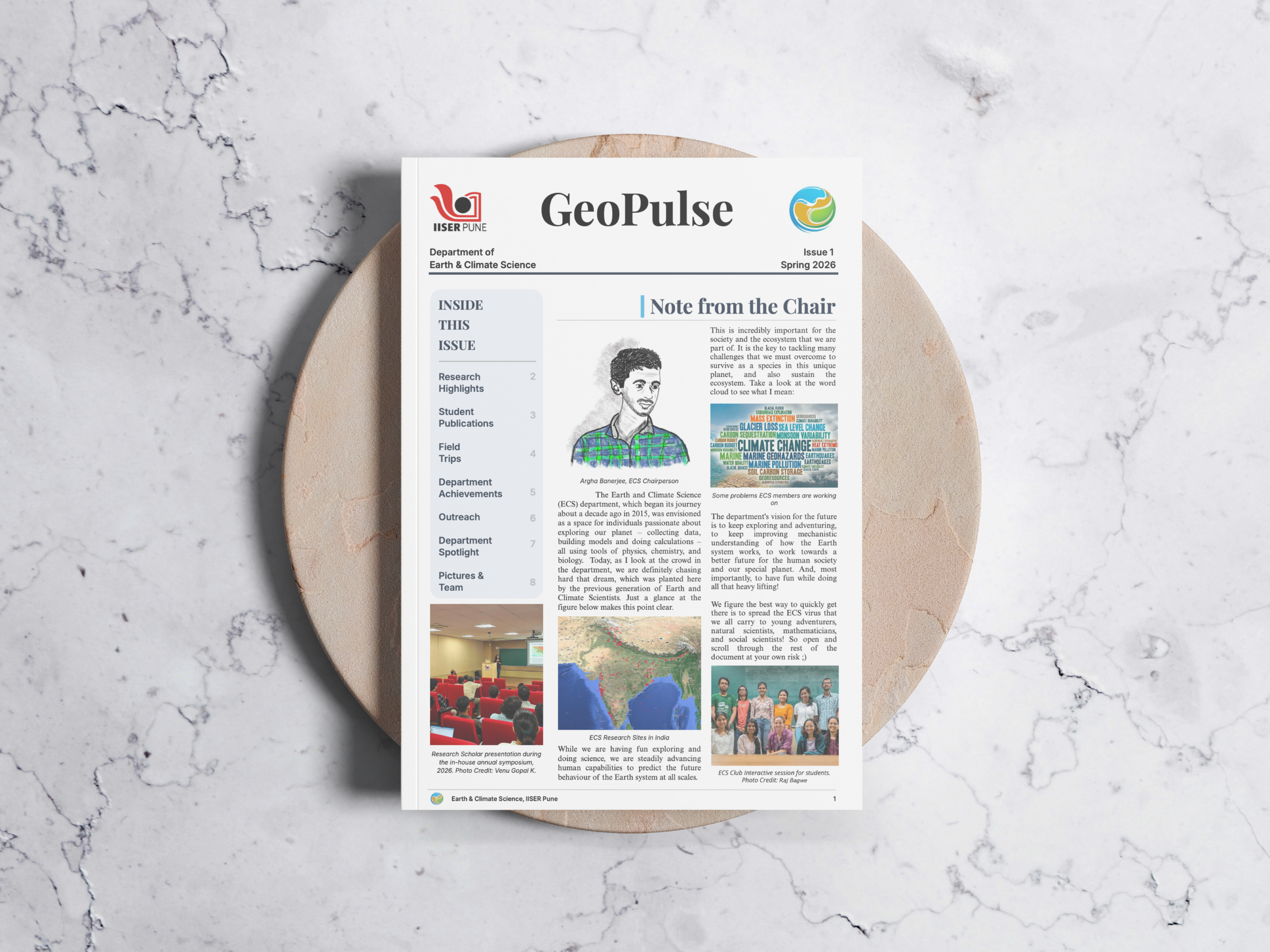 GeoPulse Spring 2026 cover displayed on a circular stone against a marble backdrop