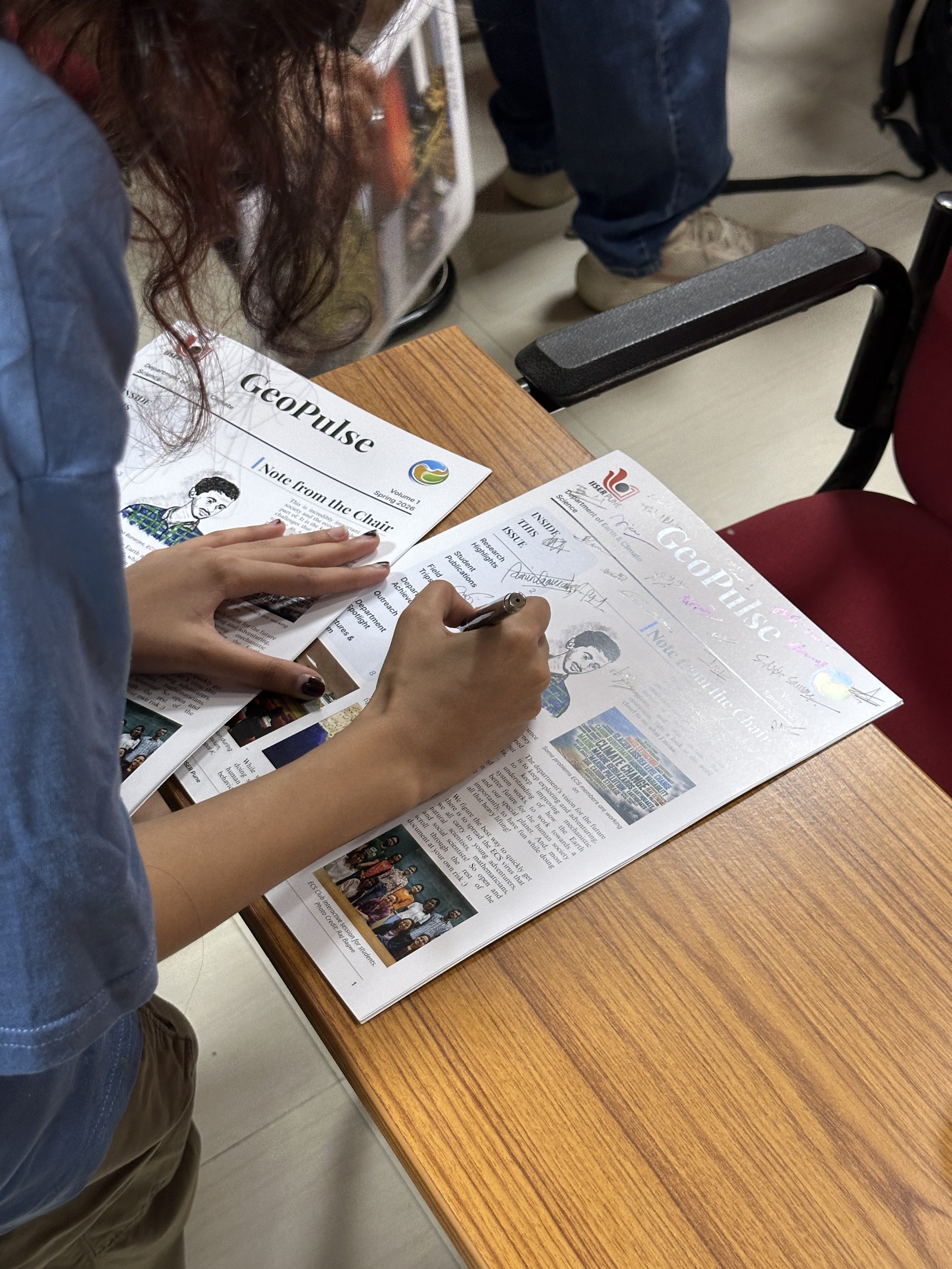 Signing copies of the printed GeoPulse newsletter