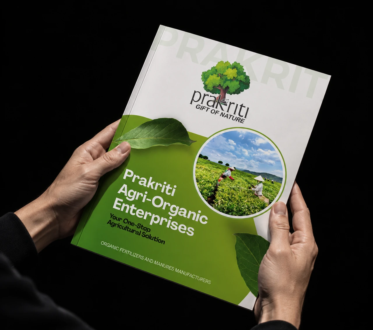 Prakriti catalogue held in two hands against a black background.